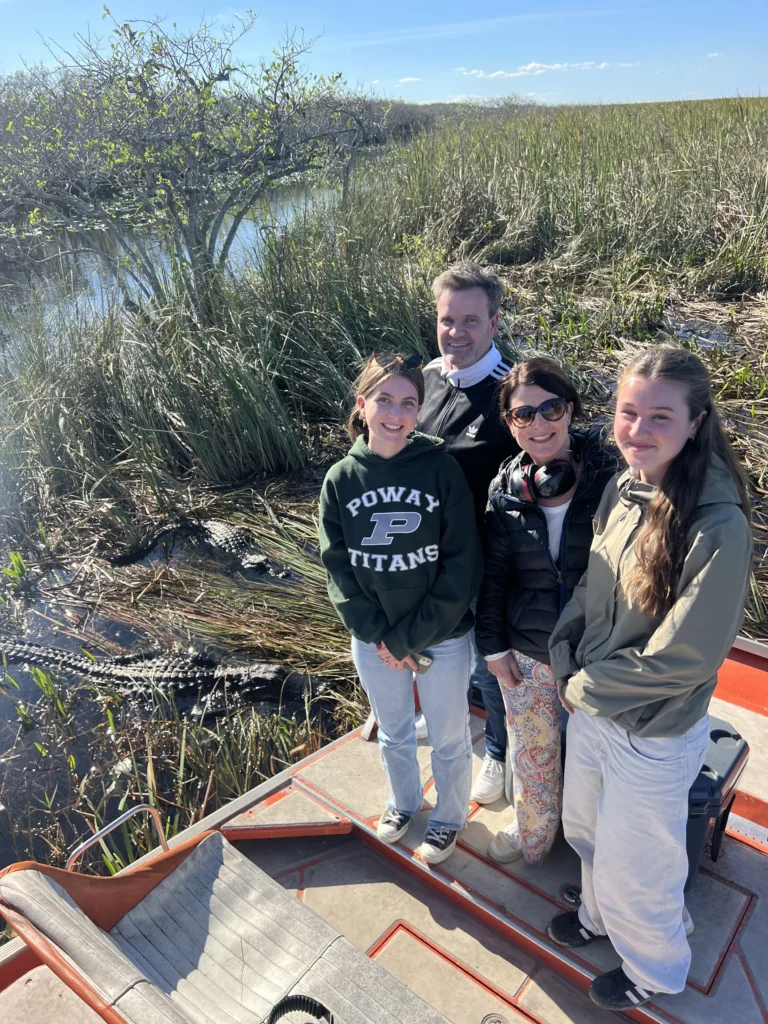 Family standing on a private airboat in the Everglades
