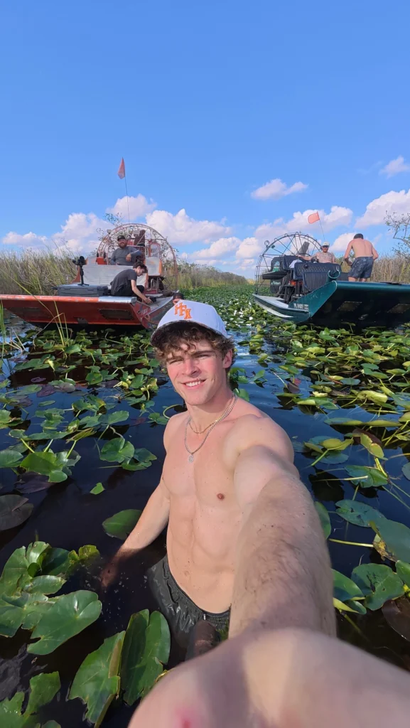 Guest taking a selfie over a lily-pad marsh on a private Everglades airboat tour