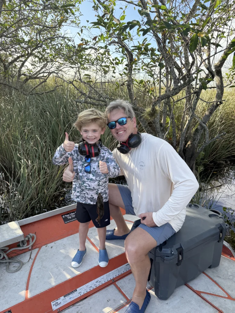 Dad and young son on a private airboat in the Everglades