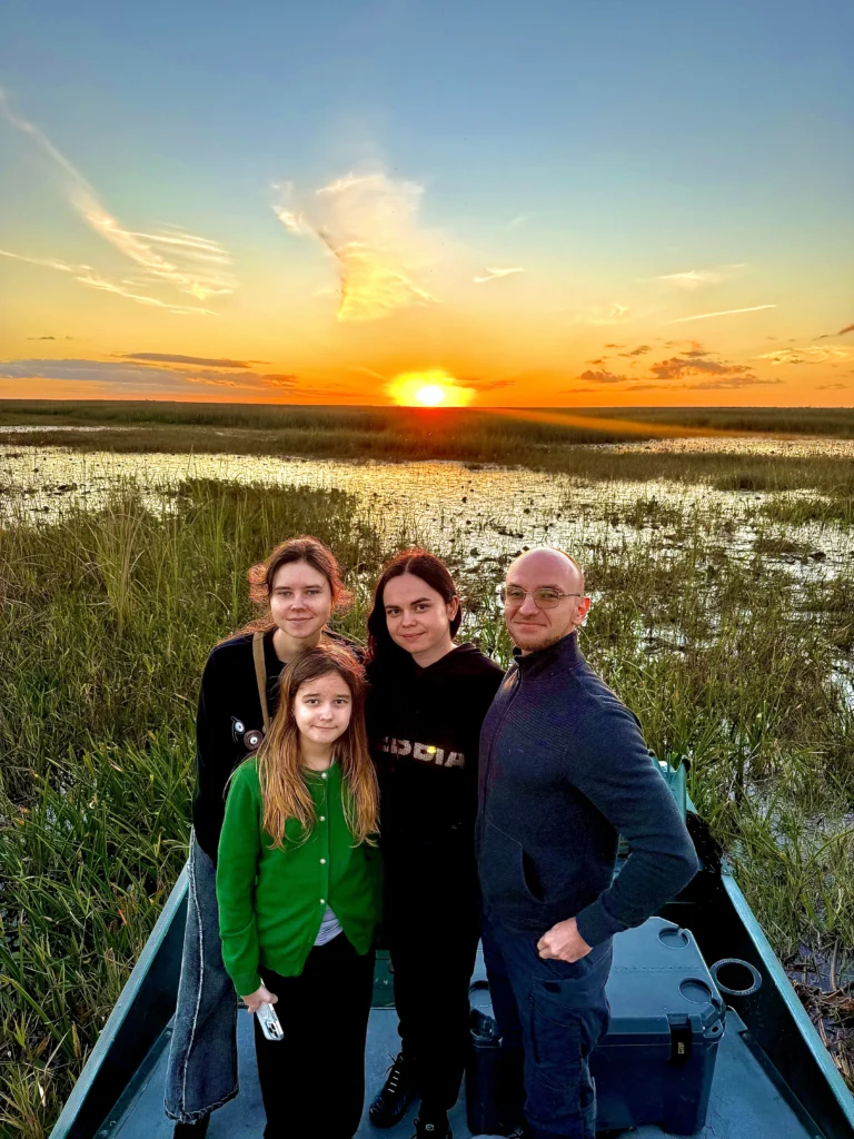Family photo on an airboat at an Everglades sunset
