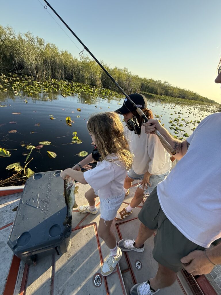 Family fishing from an airboat in the Everglades